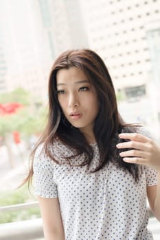 Attractive young woman, closeup glamour portrait at street in modern city, Taipei, Taiwan, Asia.