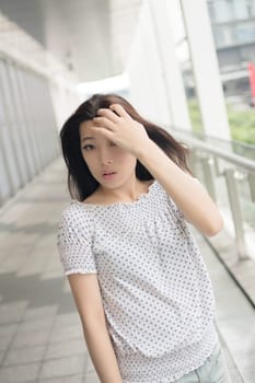 Attractive young woman, closeup glamour portrait at street in modern city, Taipei, Taiwan, Asia.