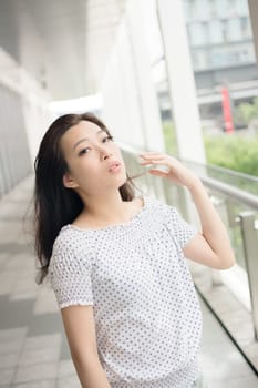Attractive young woman, closeup glamour portrait at street in modern city, Taipei, Taiwan, Asia.