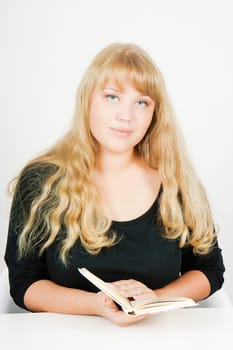 nice smiling blonde girl with a book