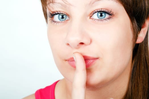 portrait of a girl put her finger to her lips