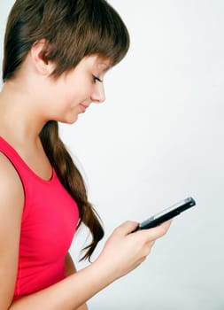 teen girl with a mobile phone reads the message