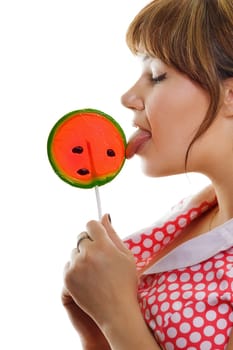 girl licks a lollipop on a white background. profile