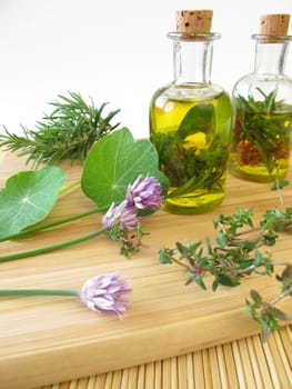Homemade herbal oil with chive flowers