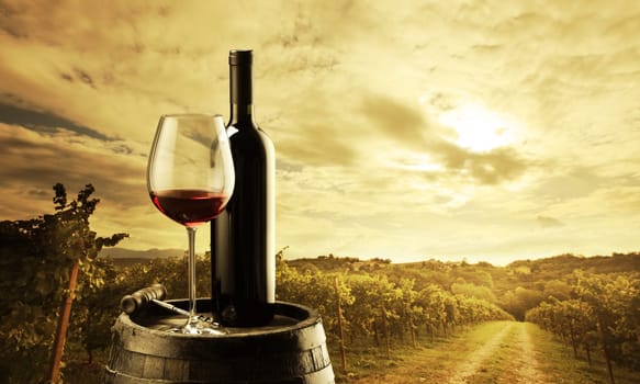red wine bottle and wine glass on wodden barrel