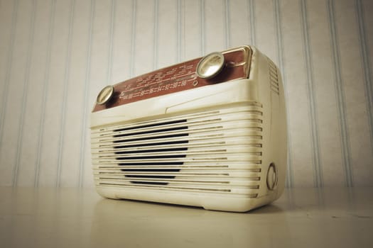 Antique radio on vintage wallpaper