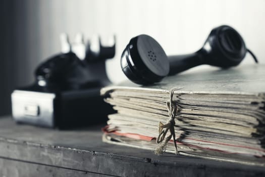 A desk with documents, Old phone on the background