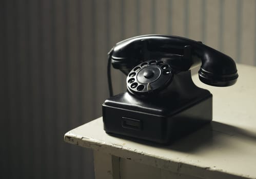 Old-fashioned phone on a wooden table