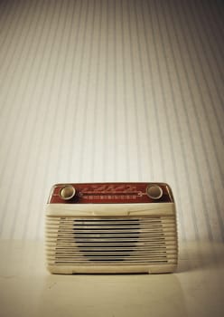 Antique radio on vintage wallpaper