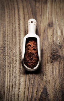 Wooden spoon full of cocoa powder, copy space