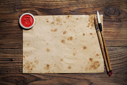 chinese brushes on wooden board, antique paper is a space for your text
