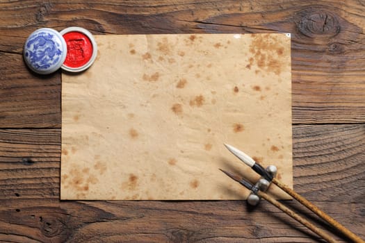 chinese brushes on wooden board, antique paper is a space for your text