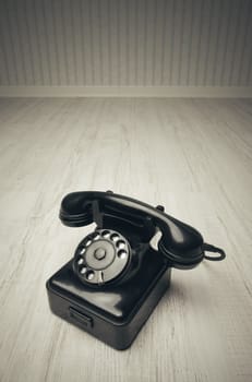 Old-fashioned phone on a wooden floor