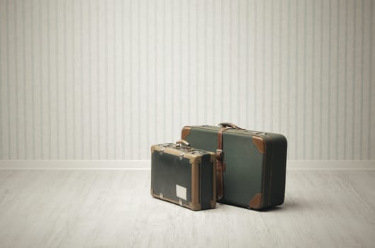 Old-fashioned suitcase alone in a room or station.