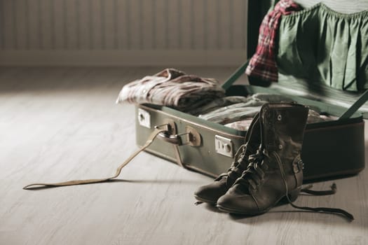 Vintage suitcase open on a wood floor, close up