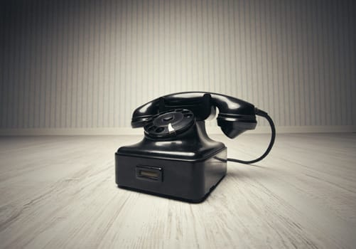 Old-fashioned phone on a wooden floor