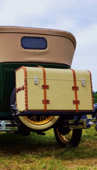 Classic car with a large suitcase
