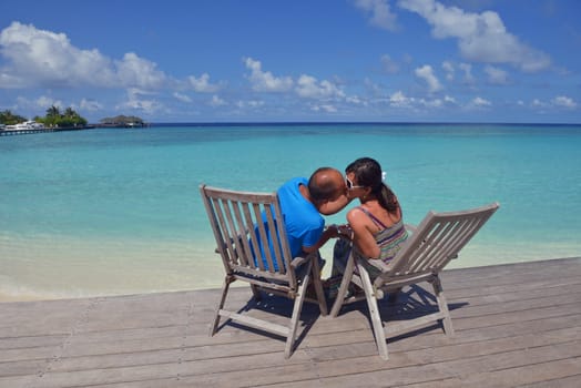 happy young couple have fun and relax at summer vacation on background maldives travel location and beautiful white sand beach