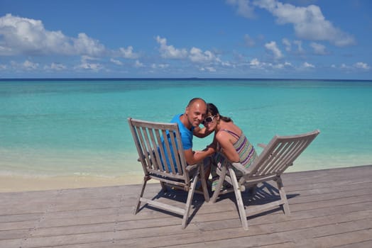 happy young couple have fun and relax at summer vacation on background maldives travel location and beautiful white sand beach