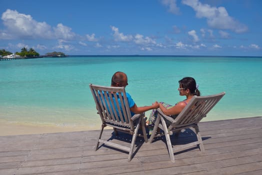 happy young couple have fun and relax at summer vacation on background maldives travel location and beautiful white sand beach