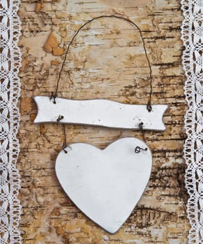 Heart with white tip on birch bark background