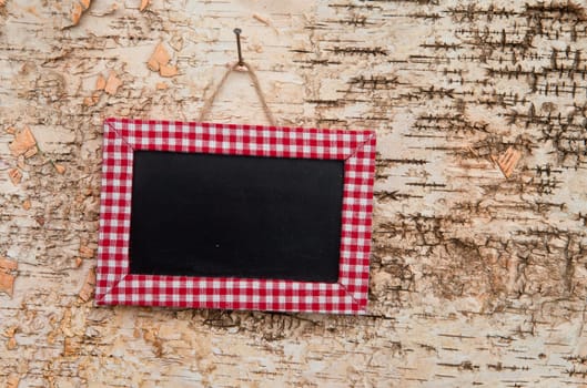 Small blackboard with free text space on birch bark background
