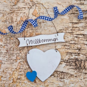 Heart with checkered bow on birch bark background