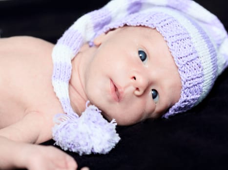 Cute beautiful baby is wearing a funny hat