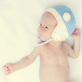 Cute beautiful baby is wearing a funny hat
