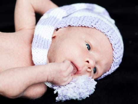 Cute beautiful baby is wearing a funny hat
