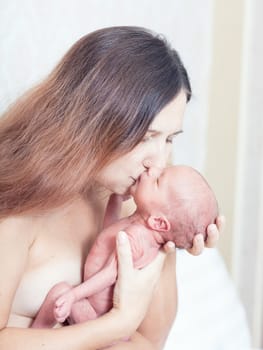 Mother holding a newborn baby skin-to-skin contact