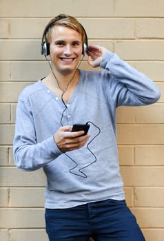 Young male listening to music on phone