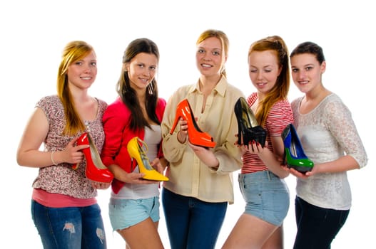 Five young women proudly display their favorite pumps at the camera. Isolated again white background.