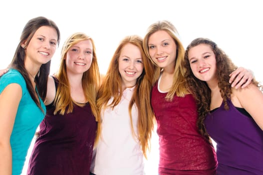 A group of five young teenager girls in casual wear smile at camera.