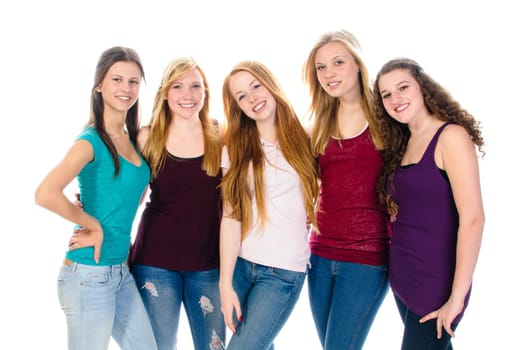 Five young teenager girls in casual wear stand together and making happy faces to the camera, isolated again white background.
