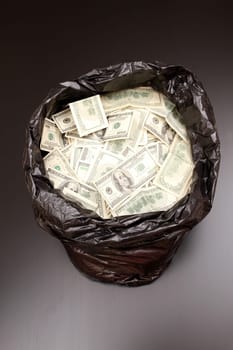 A Rubbish bag full of dollars .