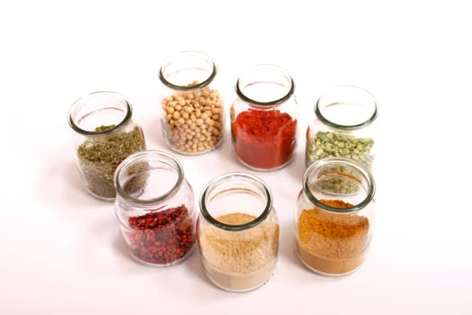 Variety of spices in a glass pot..