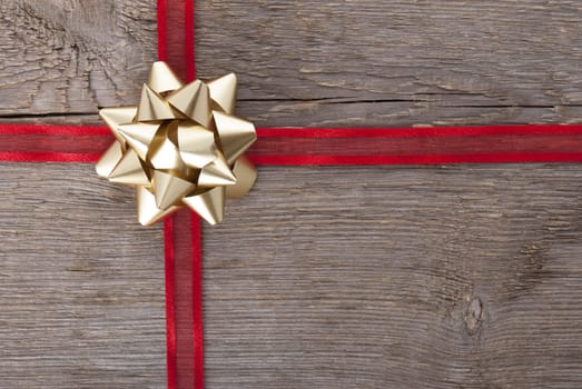 red ribbon with golden bow as present background