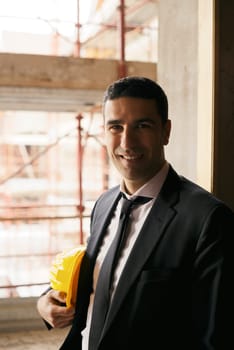Professional people at work, portrait of happy and confident architect with safety helmet in construction site, smiling at camera