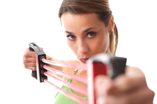 mid adult woman doing fitness exercise and training muscles with rubber band on white background