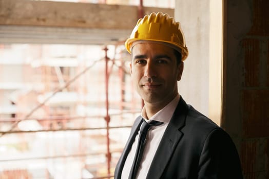 Professional people at work, portrait of happy and confident architect with safety helmet in construction site, smiling at camera