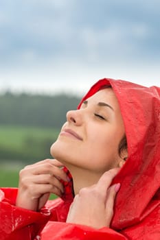 Portrait of young girl feeling the fresh rain outside