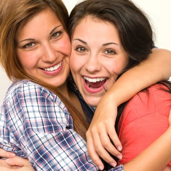 Caucasian sisters friends embracing and  laughing at camera