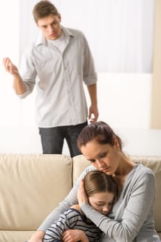 Mother protecting her daughter from angry and violent father