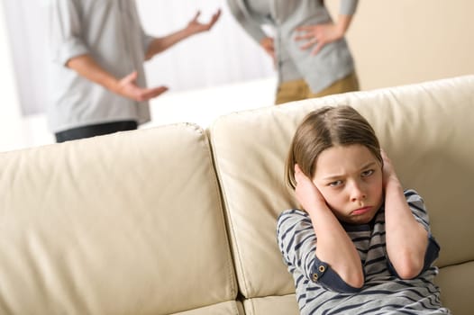 Parents fighting in front of their unhappy daughter child
