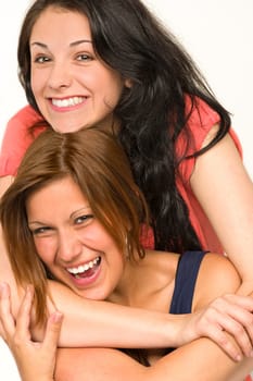 Portrait of pretty teens laughing and smiling at camera