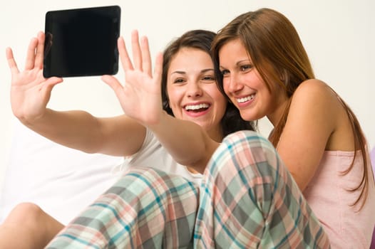 Pretty young girls taking pictures of themselves smiling