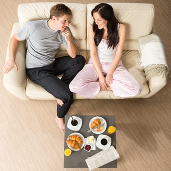 Joyful couple sitting in the morning before breakfast