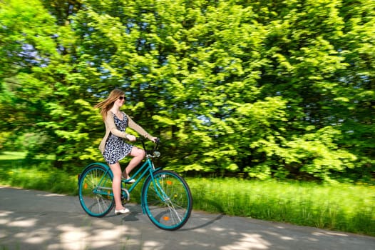 Young woman cycling during sunny summertime