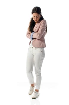 Young woman standing with folded arms sad and isolated against white background.